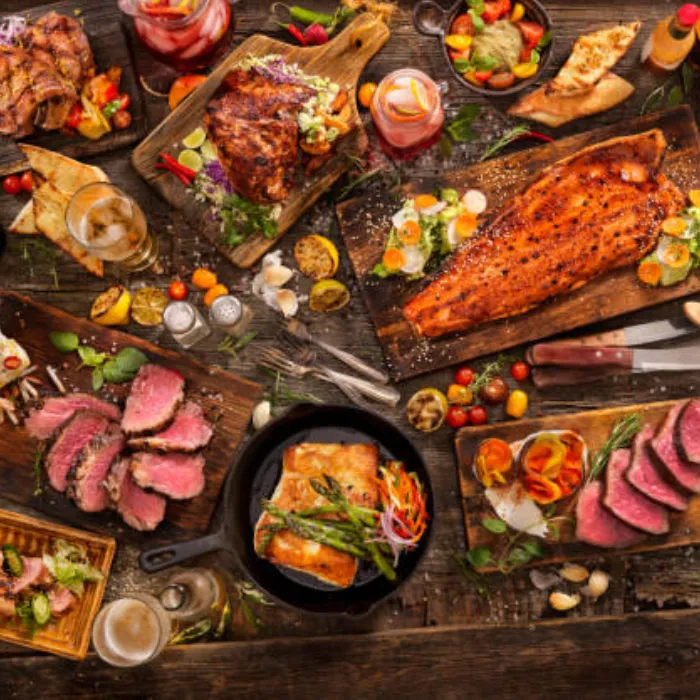 BBQ smoked meats, grilled salmon, steak and fresh sides