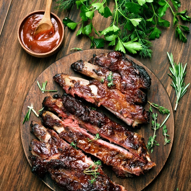 Smoked BBQ ribs with caramelised sauce and fresh herbs