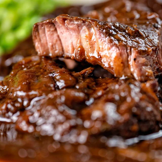 Slow-cooked braised lamb with rich smoky sauce