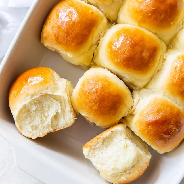 Soft golden dinner rolls with a fluffy texture