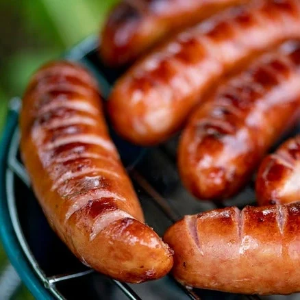 Grilled jalapeño cheese Kransky sausages with charred grill marks