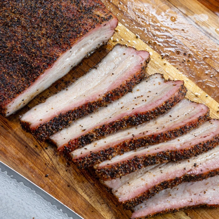 Slow-smoked beef brisket sliced with a peppery BBQ bark